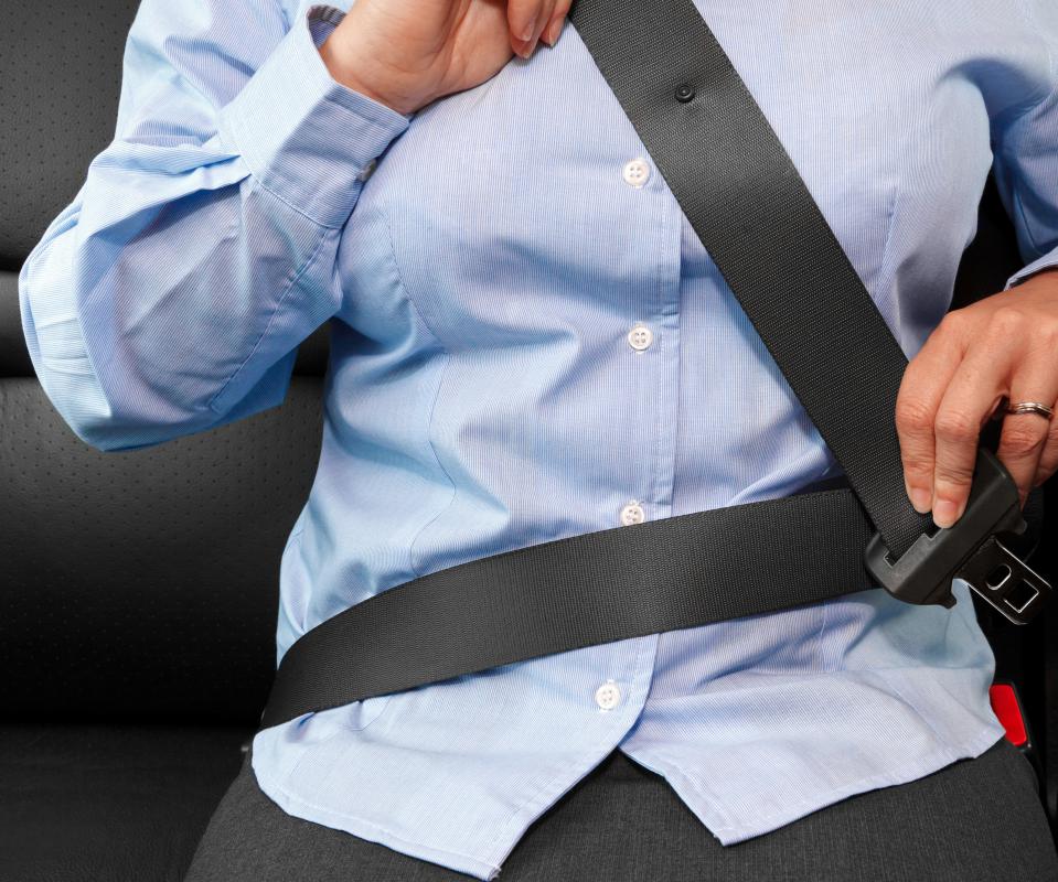 A seatbelt prevents inertia from carrying a passenger into a windshield in a front-end collision.