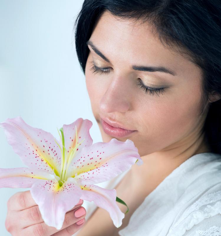 Someone who sees and smells flowers that are not present in his or her environment is experiencing a hallucination.