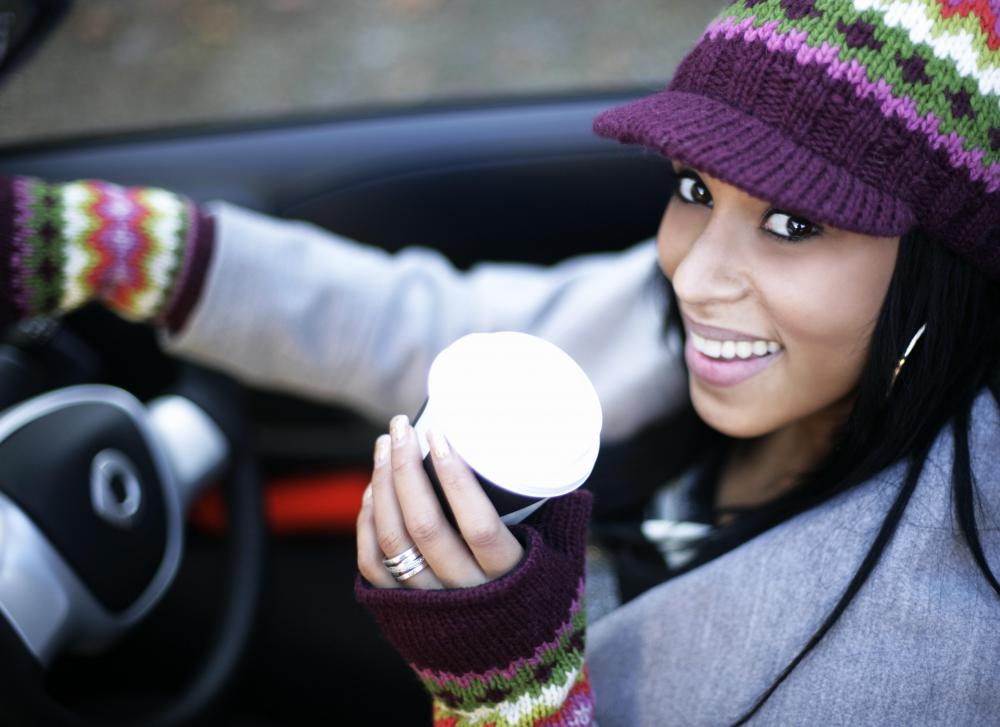 Many drivers multitask every day by drinking coffee while traveling.