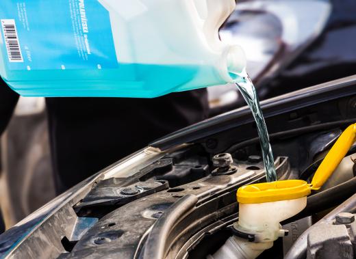 Adding antifreeze to a car.